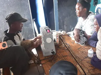 Thulani N teaches members sewing machine skills
